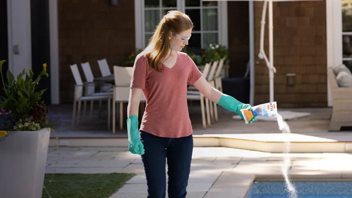 Adding pool shock to a backyard swimming pool in Phoenix AZ