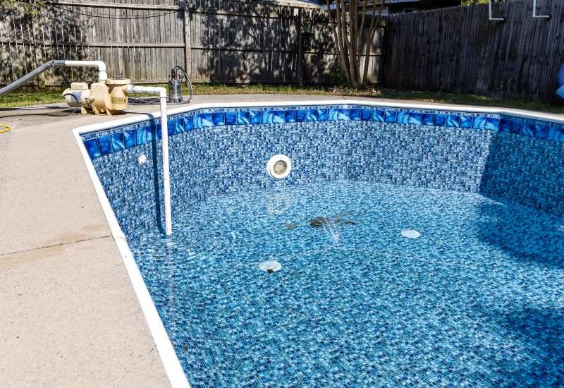Draining a pool with a submersible pump to lower cyanuric acid in Glendale AZ