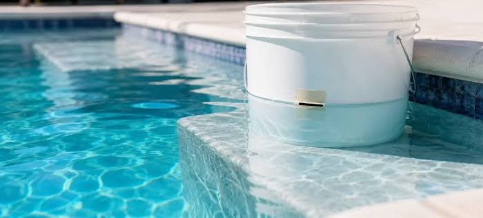 Bucket test for a pool leak set up on a pool step in North Phoenix