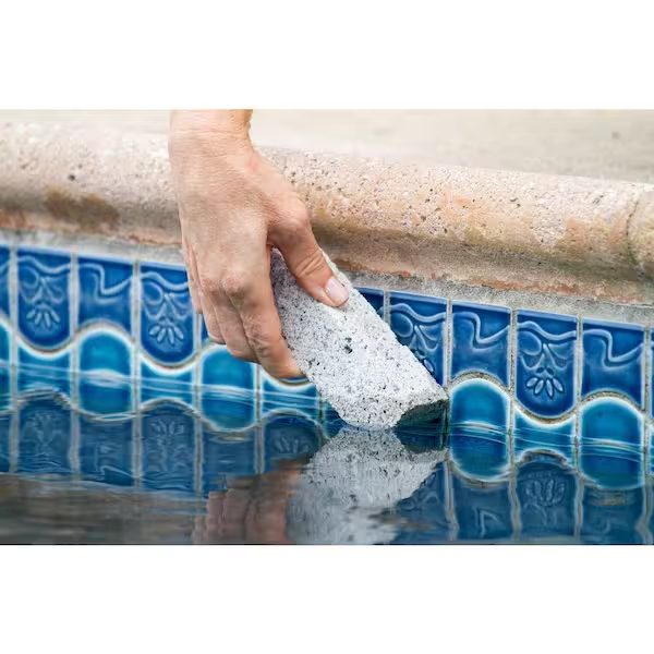Removing calcium from pool tile with a wet pumice stone in Scottsdale