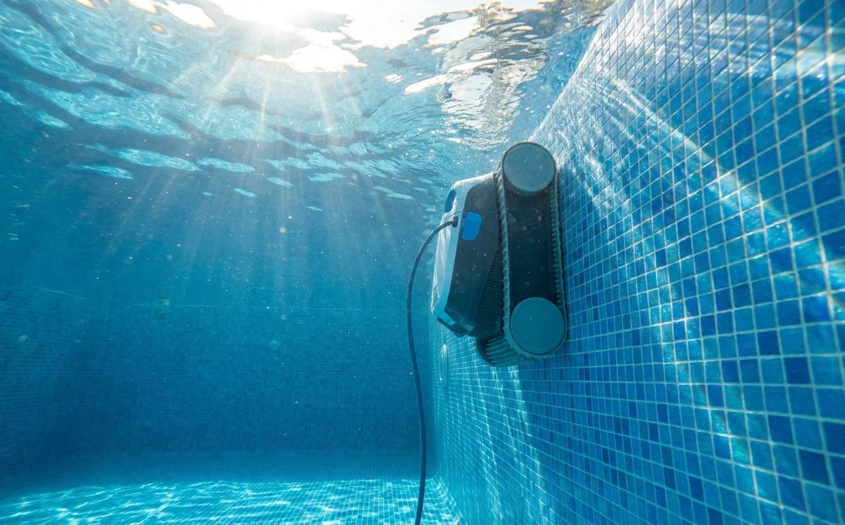 Robotic pool cleaner climbing the wall of a Peoria pool